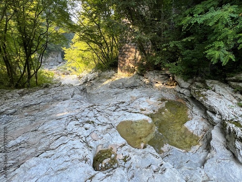 Karst rocks in the bed of the Vogršček stream along the Soča river (Gorenji Log, Slovenia) - Karstfelsen im Bett des Baches Vogrscek entlang des Flusses Soca (Gorenji Log, Slowenien) photo