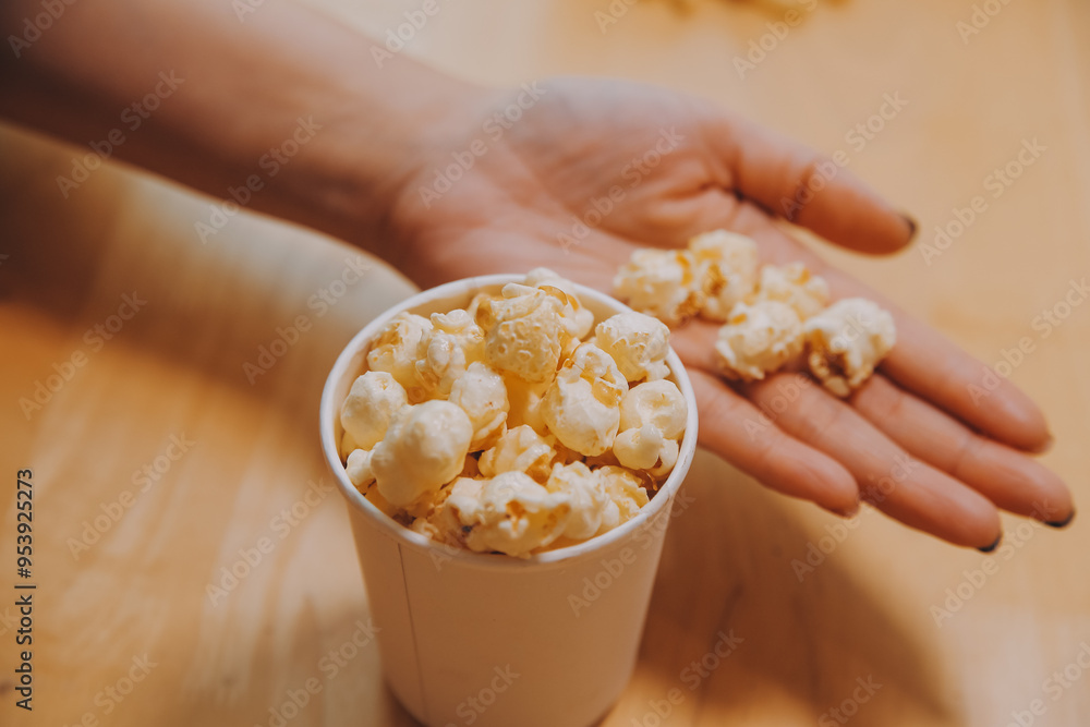 A woman holding a bowl of popcorn A woman holding a bowl of popcorn