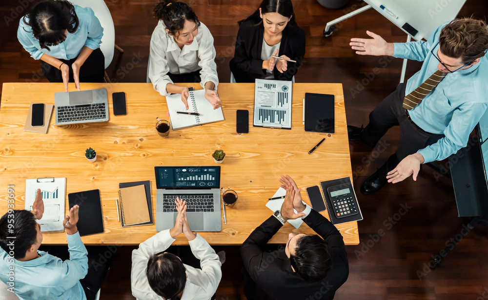 Obraz premium Panorama top view diverse group of business analyst team analyzing financial data report paper on meeting table. Chart and graph dashboard by business intelligence analysis. Meticulous