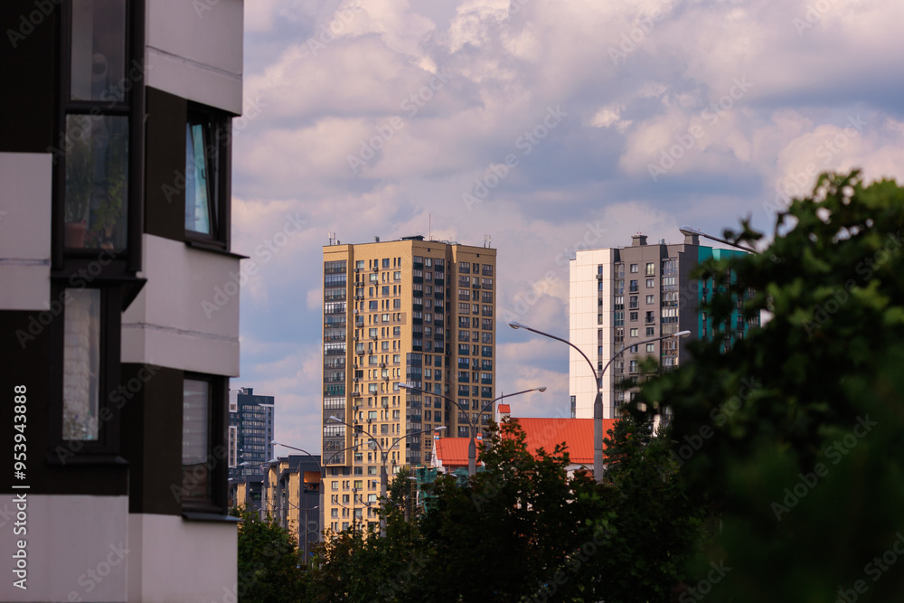 City view on a sunny day. Modern building and houses against the blue sky. City view on a sunny day. Modern building and houses against the blue sky.