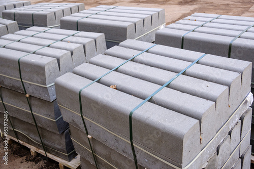 Photos Stack of packed border stones for asphalt road on wooden pallet