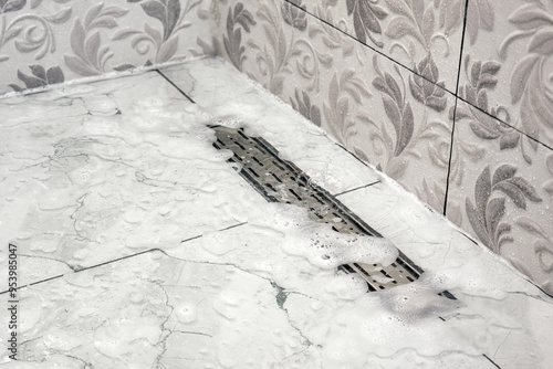 Water foam does not drain in the shower stall bathroom.