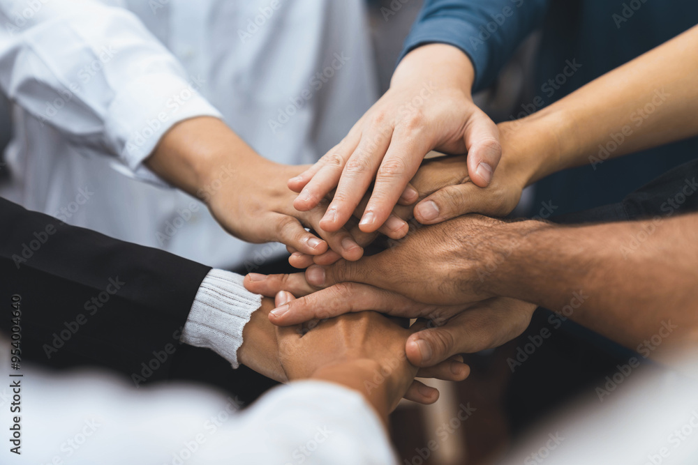 Group of diverse office worker join hand together in office room symbolize business synergy and strong productive teamwork in workplace. Cooperation and unity between business employee. Prudent Group of diverse office worker join hand together in office room symbolize business synergy and strong productive teamwork in workplace. Cooperation and unity between business employee. Prudent