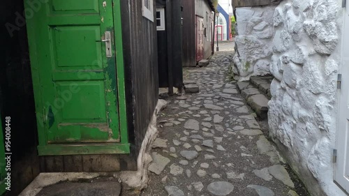 Walking down a narrow cobblestone alley in Tórshavn, the capital city of the Faroe Islands. Charming and colorful architecture in this remote Nordic country.