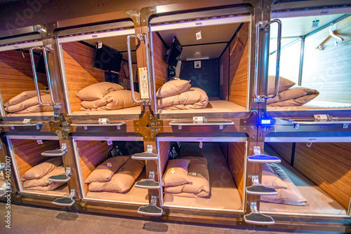 Tokyo, Japan - June 1st, 2016: Interior of Capsule Hotel with tiny rooms for guests along a long corridor