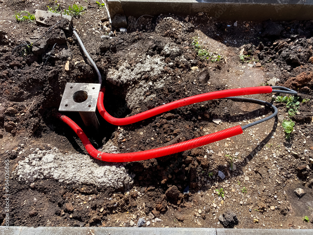 A bunch of tangled wires are laying scattered across the dirt A bunch of tangled wires are laying scattered across the dirt