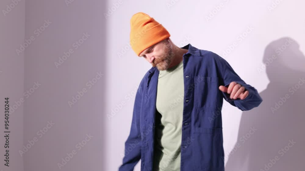 Stylish man in hat dancing on grey background Stylish man in hat dancing on grey background