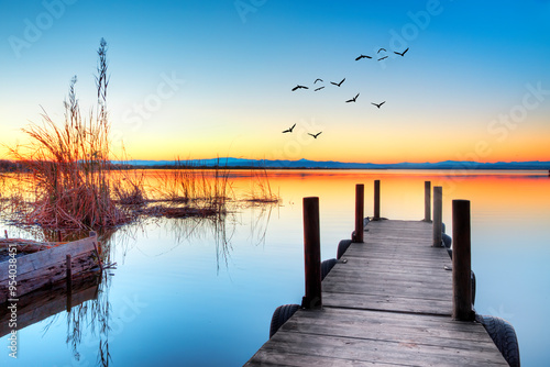 paisaje de un lago con un embarcadero y el atardecer  photo