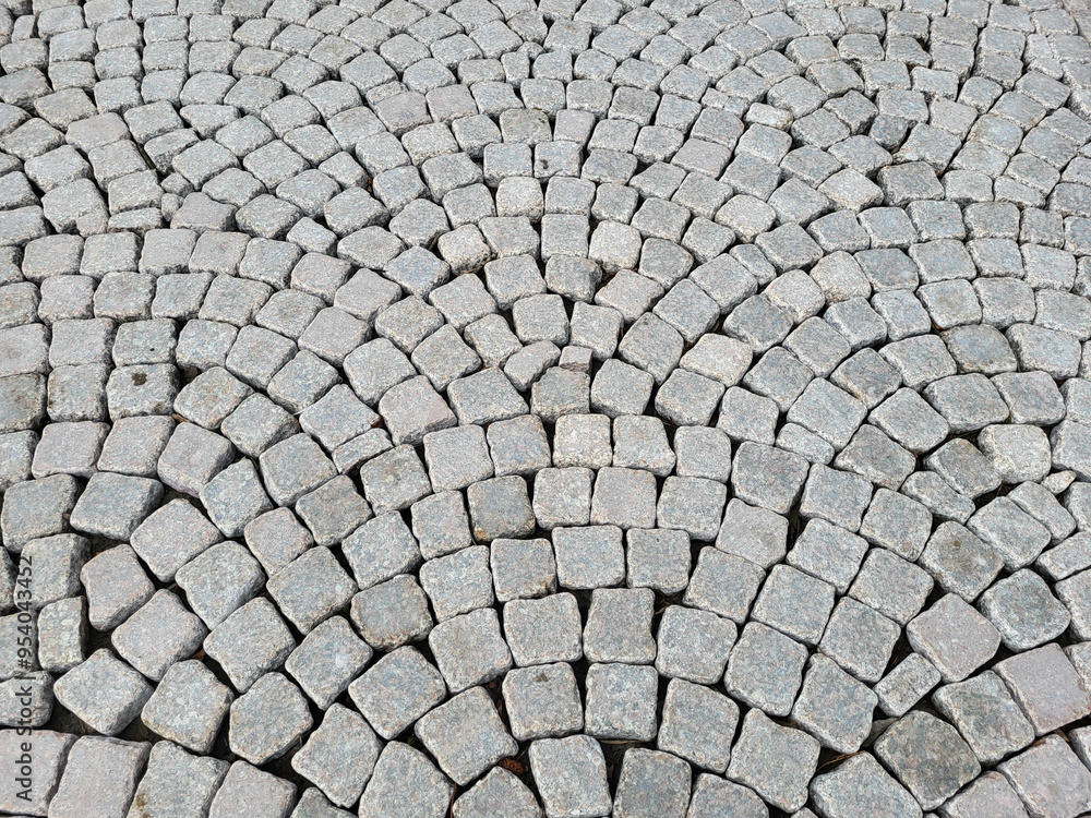 The sidewalk is lined with paving stones in a semicircular pattern The sidewalk is lined with paving stones in a semicircular pattern