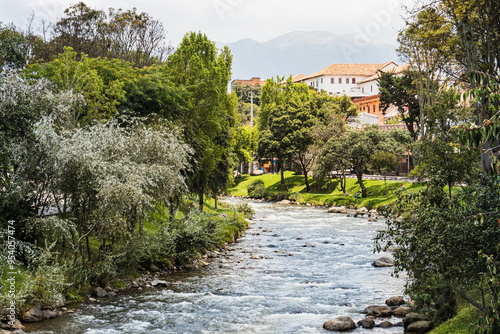 View of the Tomebamba River and the public park along the river as it crosses the center of Cuenca. Ecuador photo