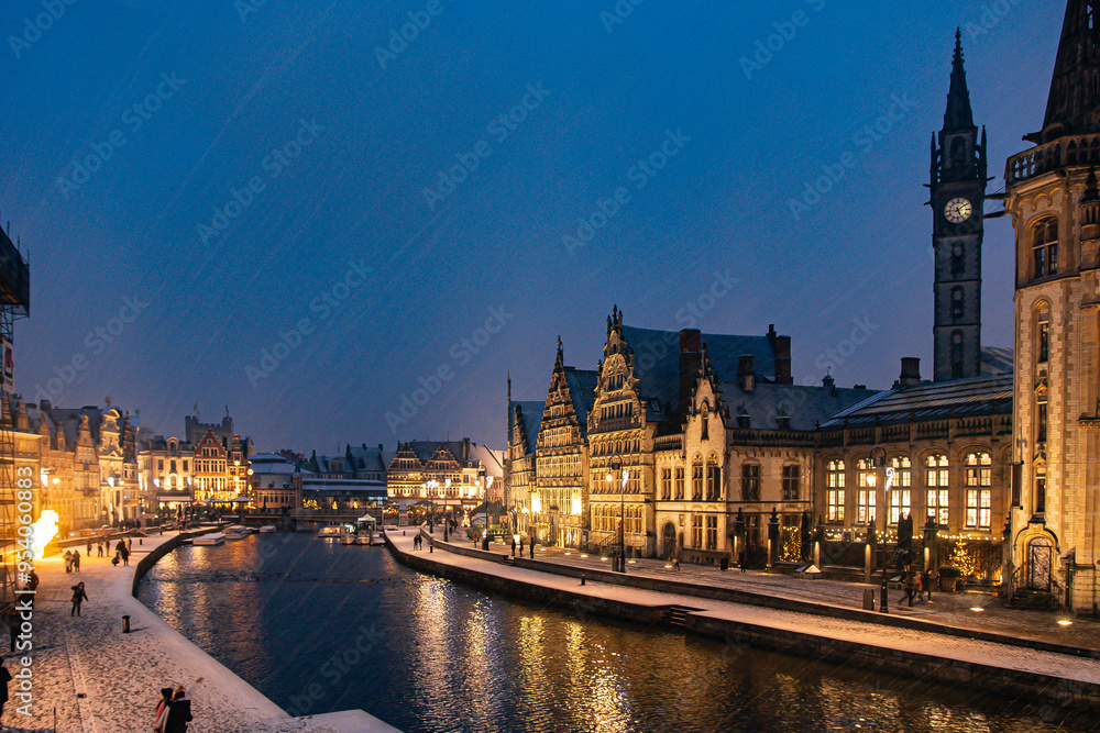Fototapeta premium Snowy Christmas Night in Ghent, Belgium with Historic Buildings and Canal