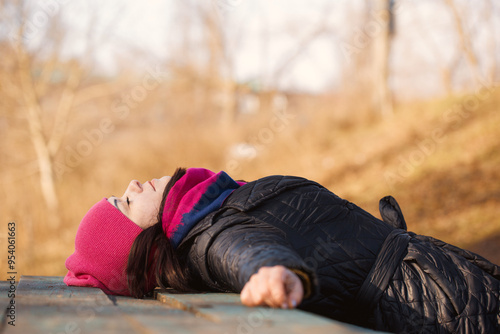 A young woman lying on a table in the garden