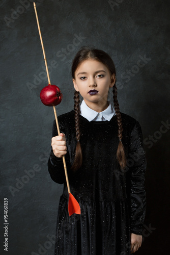 A gloomy girl holds an arrow with an apple in his hands