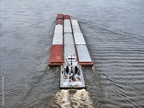 Tug boat pushing a set of 14 barges up the Mississippi River photo