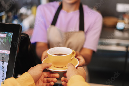 Barista giving customer cup of coffee in cafe selective focus service concept photo