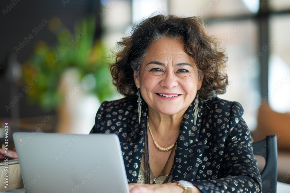 A woman is sitting at a desk with a laptop in front of her A woman is sitting at a desk with a laptop in front of her