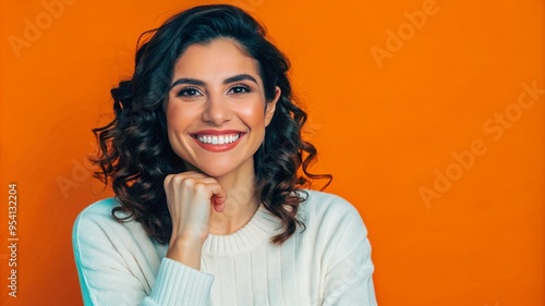 Portrait of smiling Latino woman, posing in studio shot.