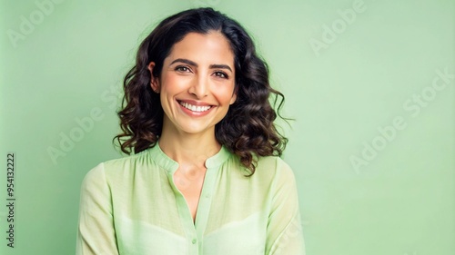 Portrait of smiling Latino woman, posing in studio shot.