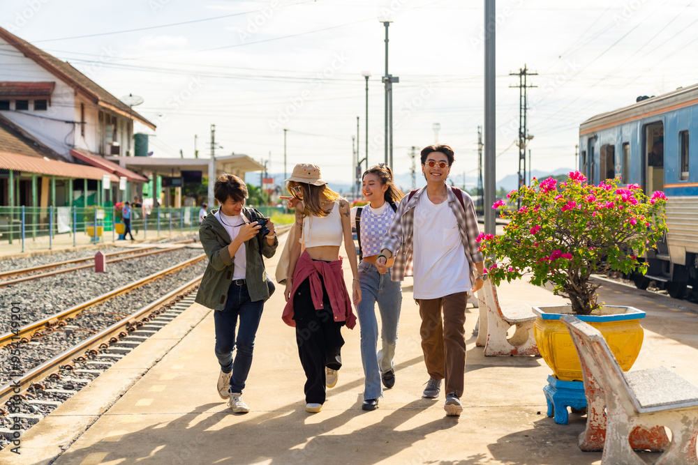 Naklejka premium Group of Asian man and woman enjoy and fun outdoor lifestyle travel countryside by railroad transportation on summer holiday vacation. Generation z people friends walking together at train station.