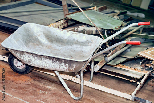 Construction metal wheelbarrow, various waste after repair photo