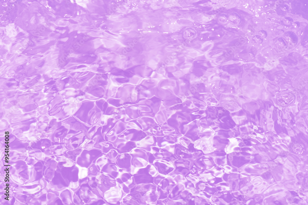 Fototapeta premium Pink water bubbles on the surface ripples. Defocus blurred transparent pink colored clear calm water surface texture with splash and bubbles. Water waves with shining pattern texture background