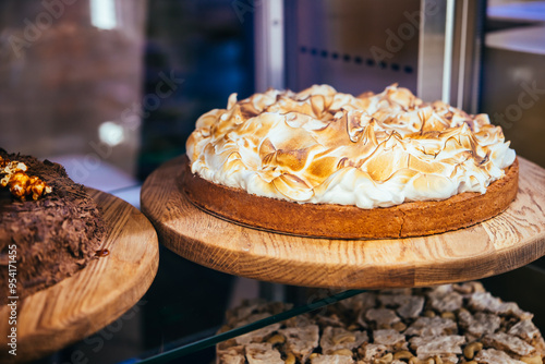 Lemon meringue cake and chokolate nut cake in sale in a bakery of a coffee shop. photo