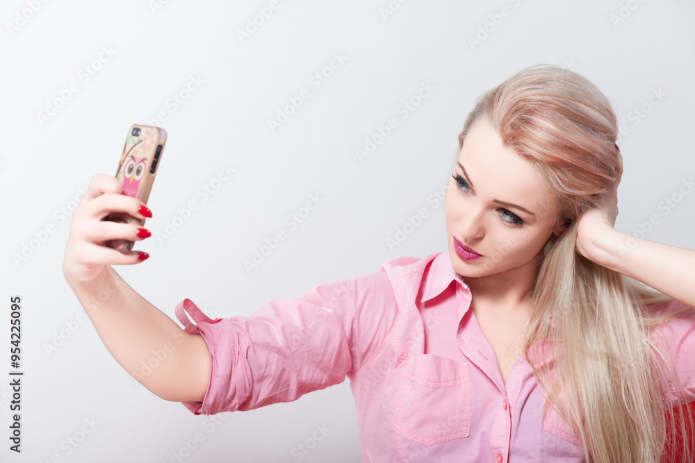 Beautiful blonde woman taking selfie with smartphone Beautiful blonde woman taking selfie with smartphone