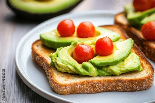 Delicious avocado toast topped with cherry tomatoes, ideal for a healthy breakfast or snack.