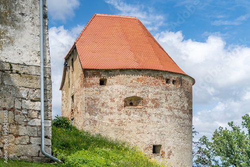 Round cannon gun tower with loopholes, red roof in Ptuj castle Slovenia