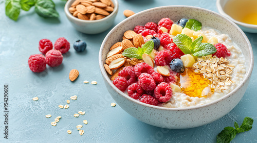 Healthy breakfast bowl with oatmeal, fresh fruit, nuts, and honey, perfect for a nutritious morning meal.