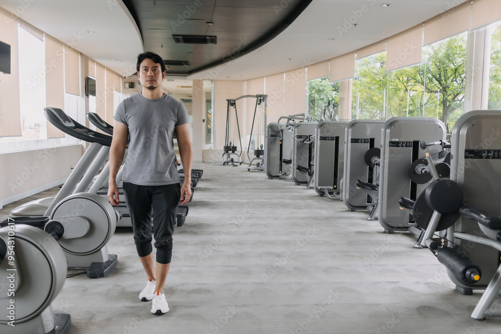 Asian Thai man walking in gym after done workout exercise, happy and healthy strong concept. Asian Thai man walking in gym after done workout exercise, happy and healthy strong concept.