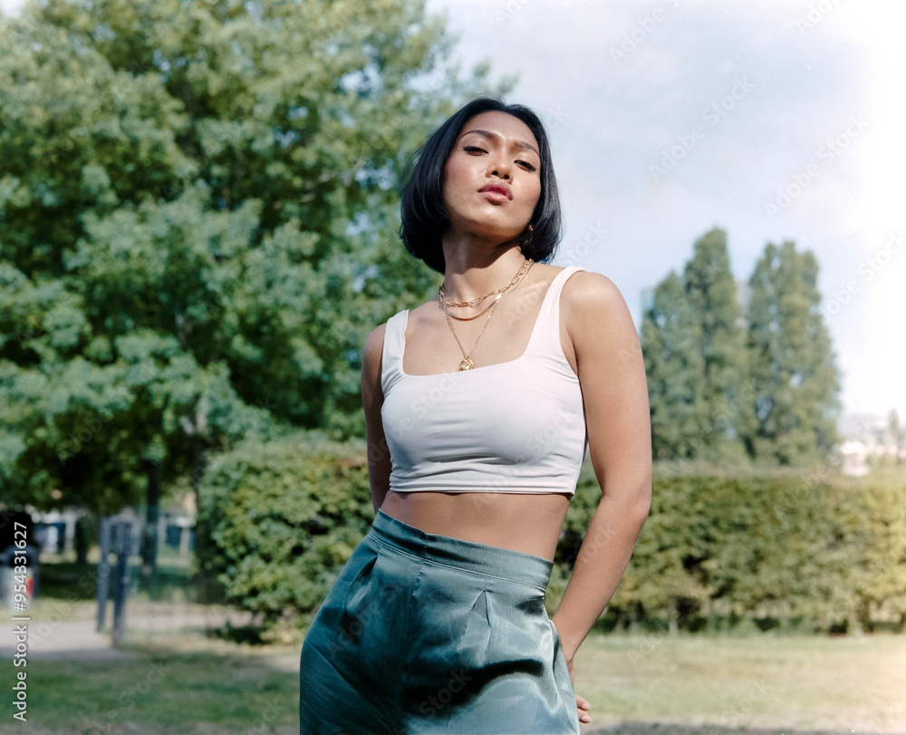Confident asian woman posing in a park.