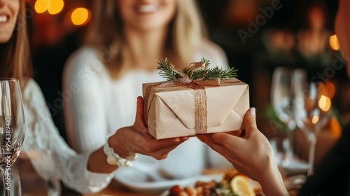 People and holidays: a woman hands a birthday present at a restaurant.