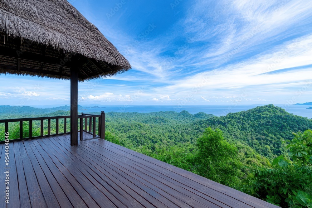 Stunning view from a wooden deck overlooking lush green mountains and a serene blue ocean under a clear sky. Stunning view from a wooden deck overlooking lush green mountains and a serene blue ocean under a clear sky.