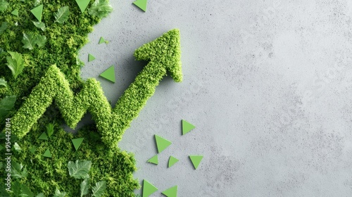 Green upward arrow made of grass, symbolizing growth and environmental sustainability on a concrete background.