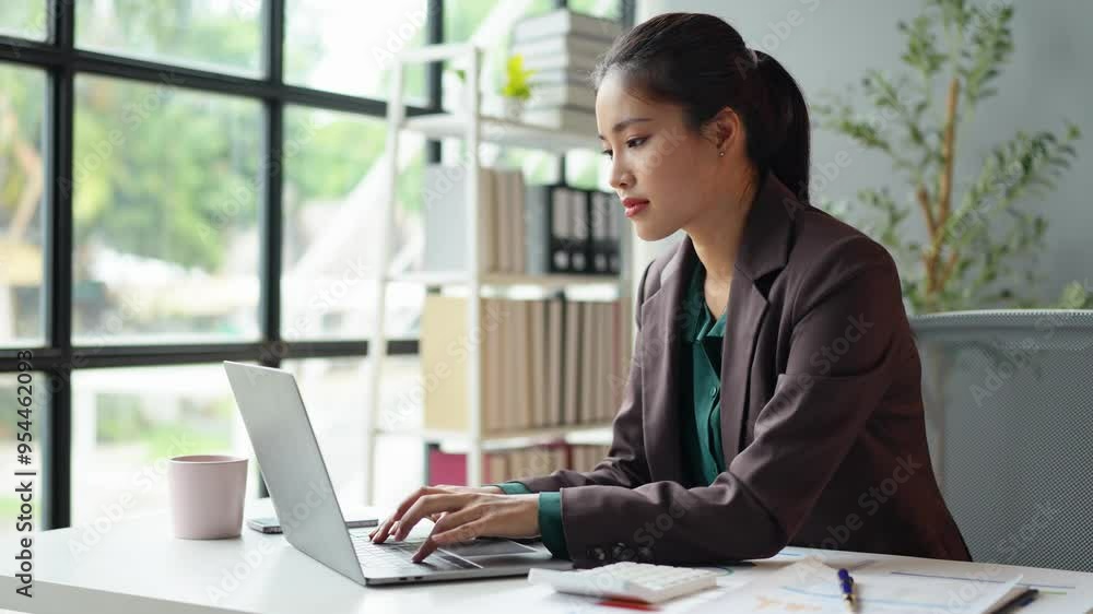 Businesswoman who is tired, sleepy and bored from sitting at a desk for a long time and has office syndrome Asian businesswoman with a headache Stressed with piles of paperwork on your desk. Businesswoman who is tired, sleepy and bored from sitting at a desk for a long time and has office syndrome Asian businesswoman with a headache Stressed with piles of paperwork on your desk.