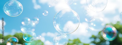 Wallpaper Mural  A scene of soap bubbles drifting in blue sky, surrounded by green foliage trees Torontodigital.ca