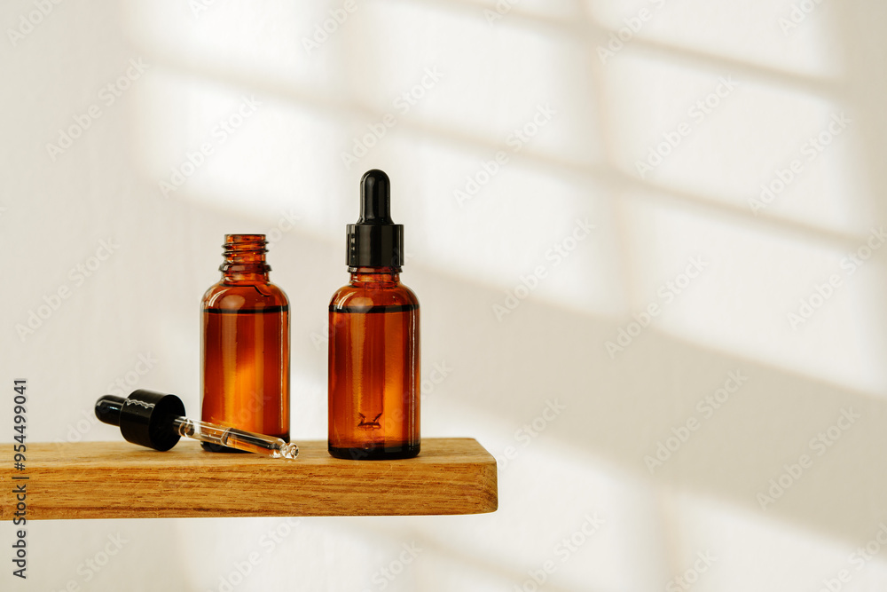 Collection of Amber Glass Dropper Bottles Displayed on a Minimalist White Surface in Natural Light Collection of Amber Glass Dropper Bottles Displayed on a Minimalist White Surface in Natural Light
