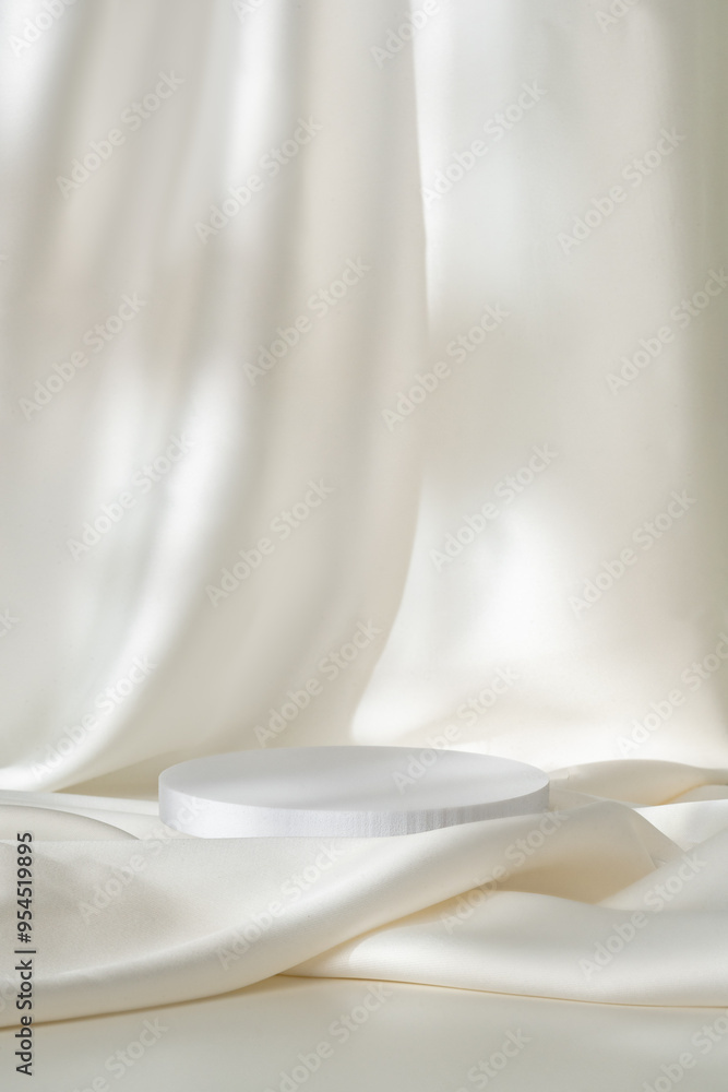 Modern Minimalist White Sculpture Displayed on Soft Draped Fabric in Natural Light Modern Minimalist White Sculpture Displayed on Soft Draped Fabric in Natural Light