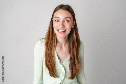 Smiling Young Woman Against White Background in Studio