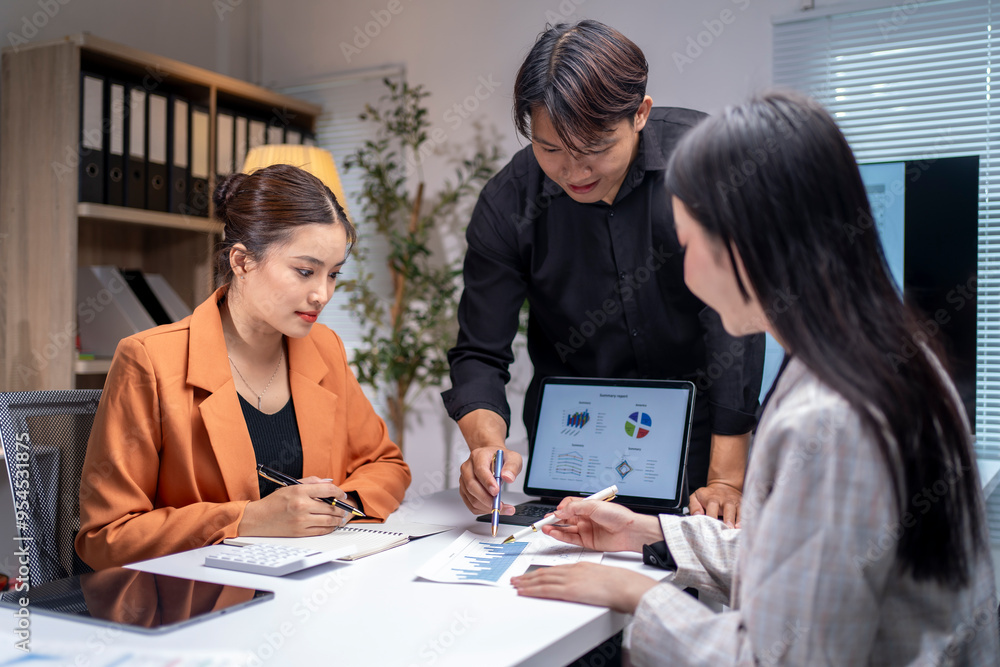 Businesspeople having a discussion about marketing strategy, working together as a team in boardroom Businesspeople having a discussion about marketing strategy, working together as a team in boardroom