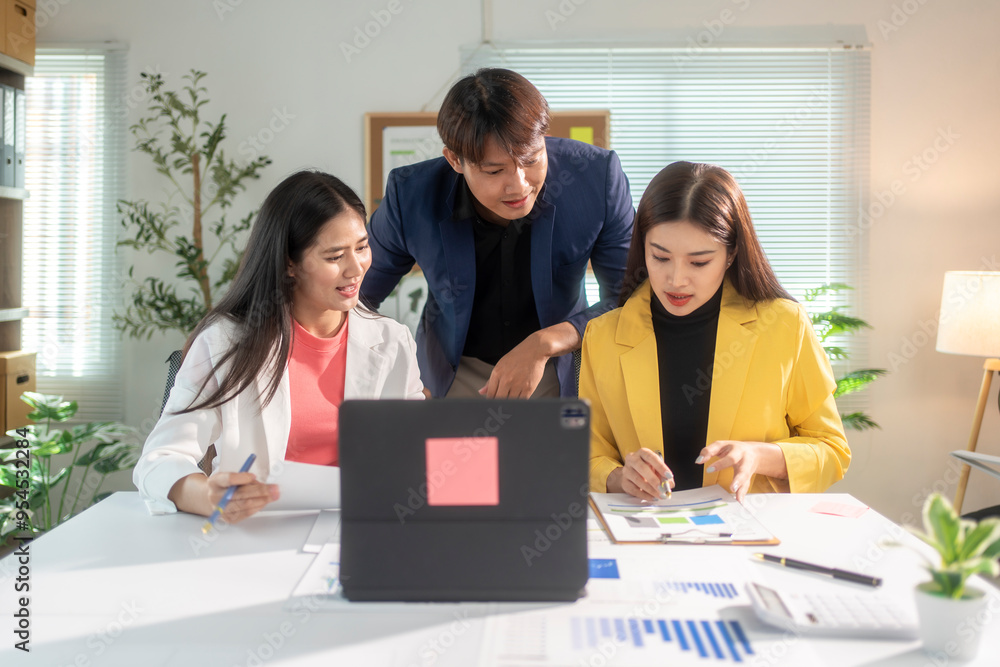 Obraz premium Asian business team working and brainstorming with data on a table in office meeting room