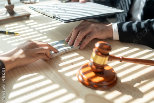 Client giving bribe money to lawyer in office after signing agreement for litigation