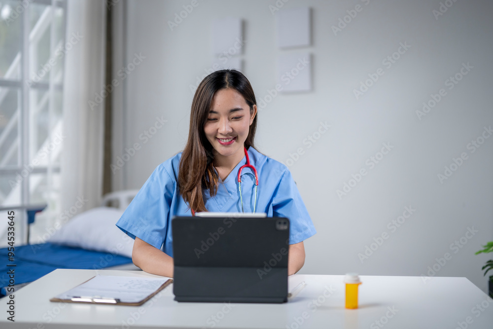 Smiling asian female doctor working with a tablet at the hospital Smiling asian female doctor working with a tablet at the hospital