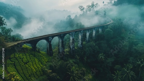 Wallpaper Mural Aerial shot of the Nine Arches Bridge in Ella, surrounded by lush jungle and tea fields, with a misty backdrop Torontodigital.ca