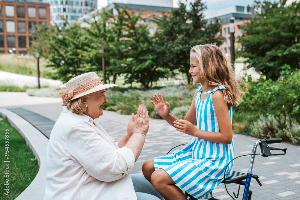 Grandma having fun with granddaugter in the city. Girl sitting on ...
