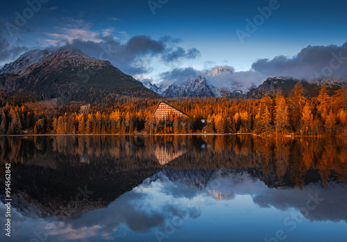 Strbske Lake, Slovakia - Panoramic view of reflecting iconic Strbske Lake (Strbske Pleso) on a sunny autumn afternoon with High Tatras and Tatras Tower at background. Warm autumn colors, blue sky photo