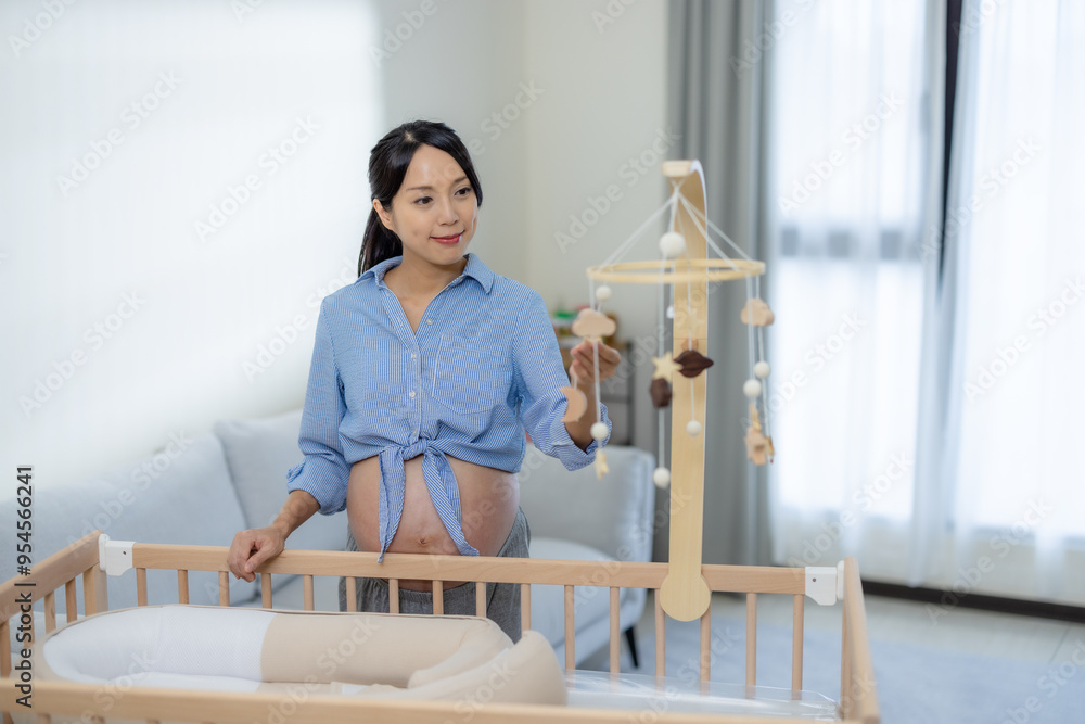 Pregnant woman prepare baby bed at home Pregnant woman prepare baby bed at home