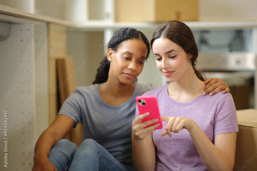 Interracial roommates checking phone moving home Interracial roommates checking phone moving home