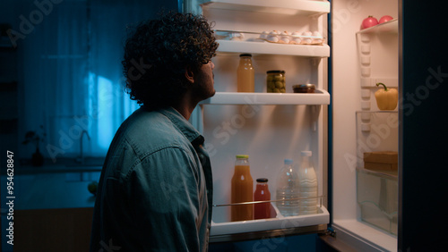 Konstfotografi Home kitchen at night dark room hungry Hispanic man Indian male guy want eat rub
